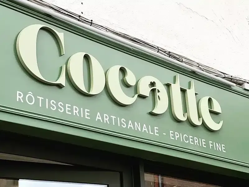 Enseigne en lettres relief de la rôtisserie Cocotte sur devanture verte